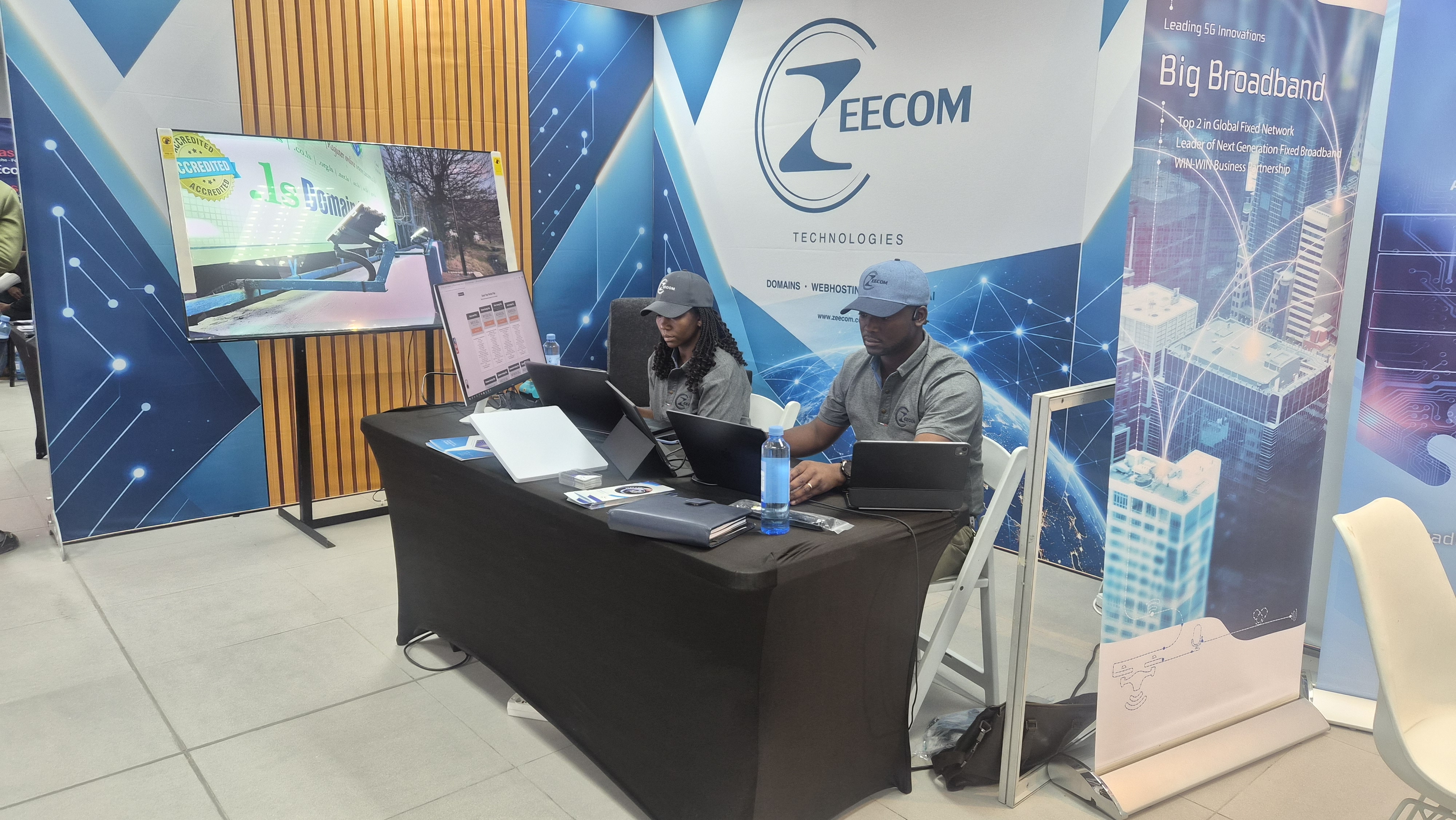 The Zeecom exhibition stand with the team demonstrating technology